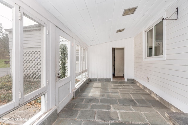 unfurnished sunroom with wood ceiling