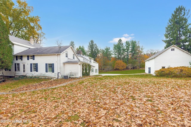 view of home's exterior with central AC and a lawn