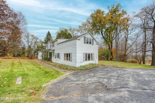 view of home's exterior with a lawn