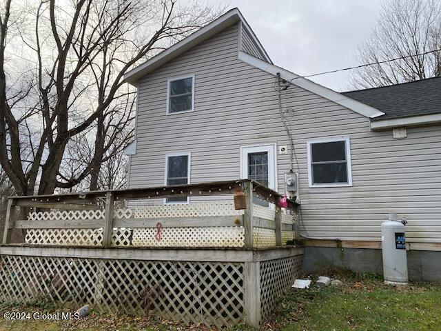 rear view of house featuring a deck