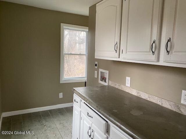 kitchen featuring white cabinets and a healthy amount of sunlight