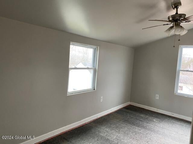 spare room featuring ceiling fan and a healthy amount of sunlight