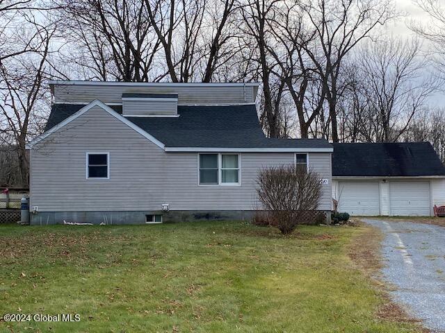 view of property exterior with a yard and a garage