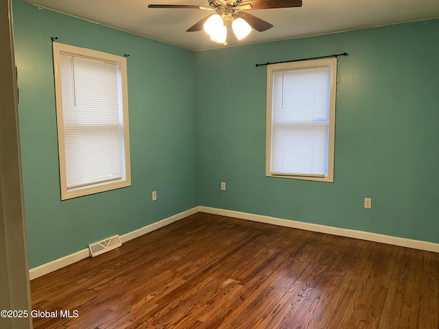 unfurnished room with dark hardwood / wood-style flooring and ceiling fan