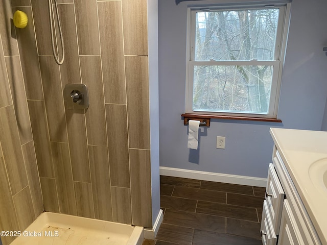 bathroom featuring a shower and vanity