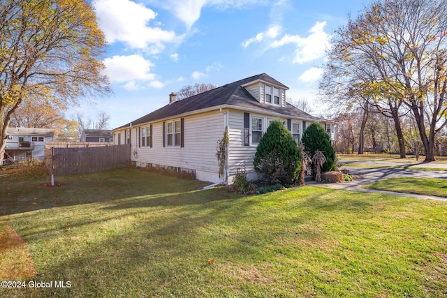 view of side of home featuring a lawn