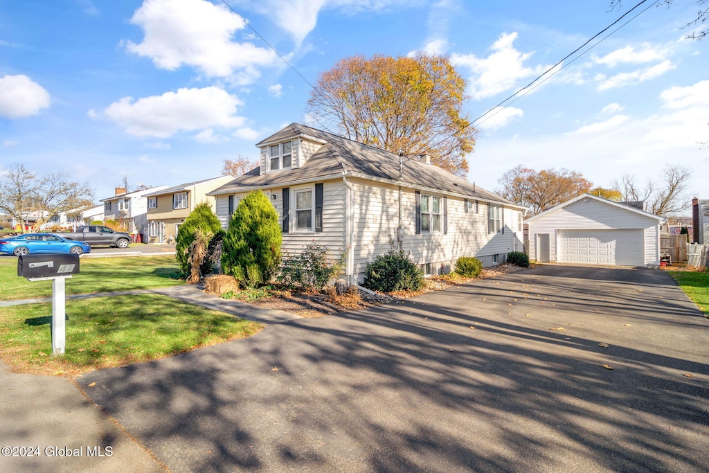 view of front of property featuring a garage and an outbuilding