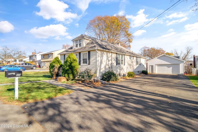 view of front of property featuring a garage and an outbuilding