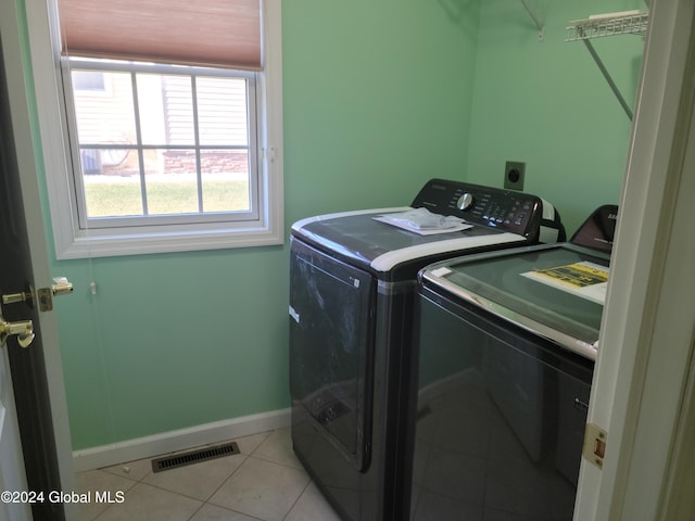 laundry area featuring independent washer and dryer and light tile patterned floors