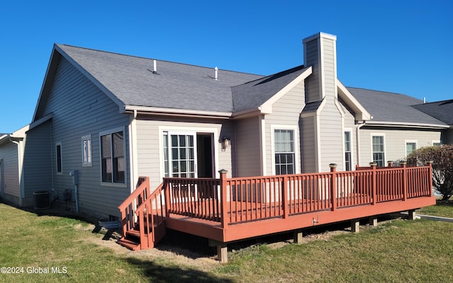 back of house with a lawn and a deck