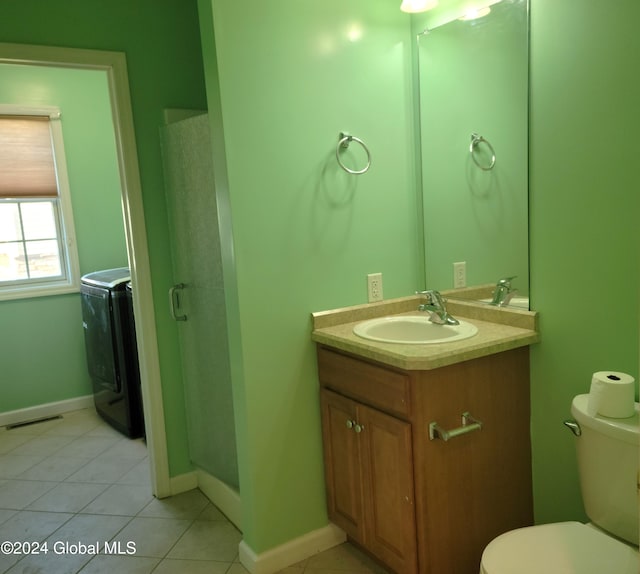 bathroom with toilet, washer / dryer, vanity, and tile patterned floors