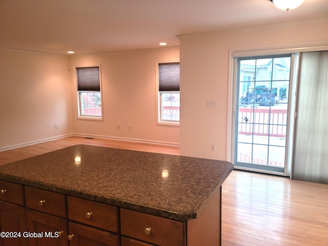 kitchen featuring dark stone countertops and light wood-type flooring