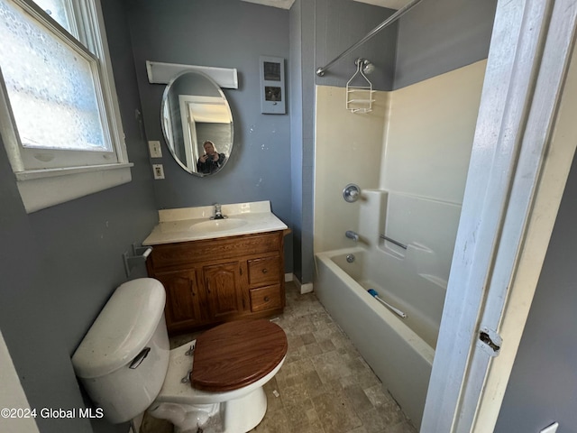 full bathroom featuring washtub / shower combination, vanity, and toilet