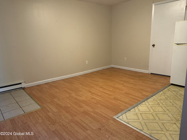 spare room with light hardwood / wood-style floors and baseboard heating