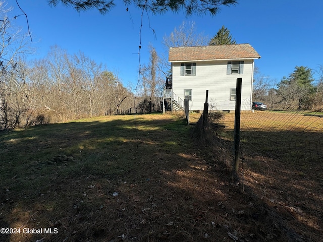 view of property exterior featuring a lawn