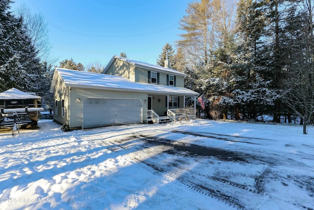 front of property with a porch and a garage