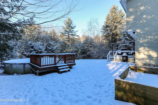 snowy yard featuring a gazebo and a deck