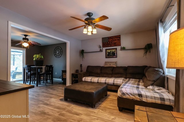 living room featuring light wood-type flooring and ceiling fan