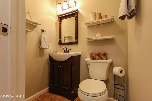 bathroom with tile patterned flooring, vanity, and toilet