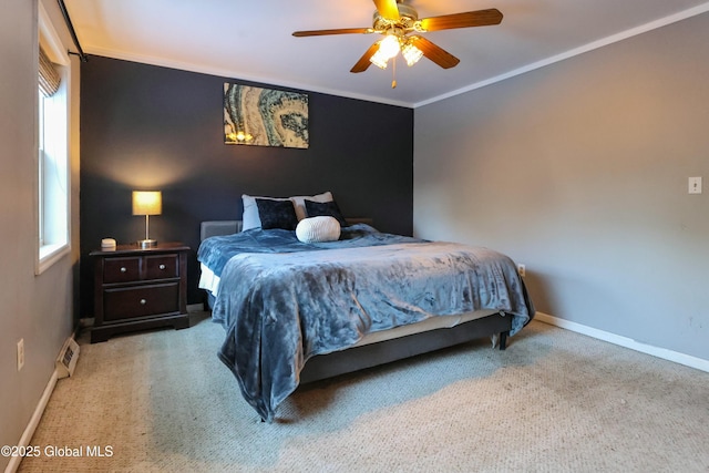 carpeted bedroom with ceiling fan and ornamental molding