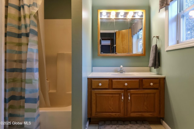 bathroom with shower / tub combo and vanity