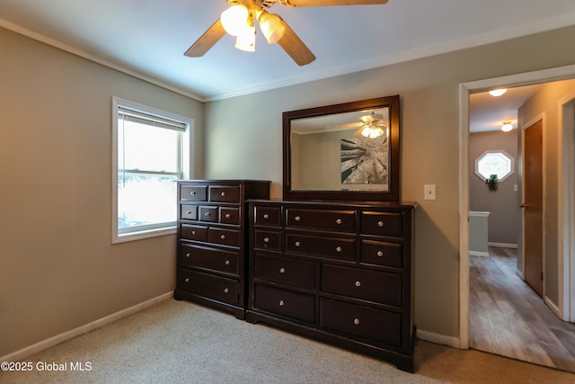 bedroom with ceiling fan, light colored carpet, and ornamental molding