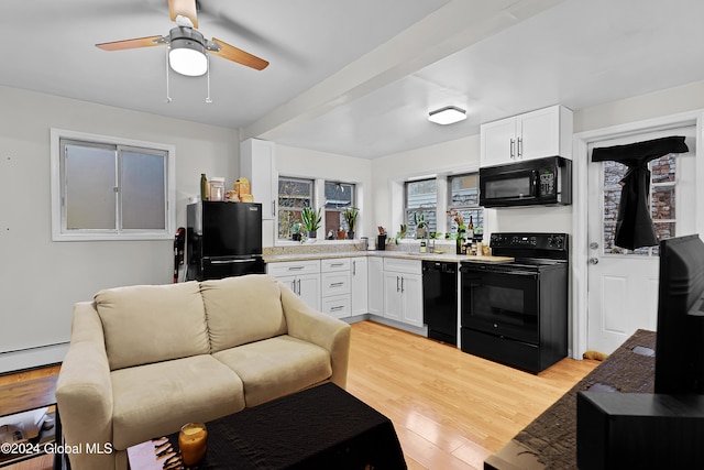 living room featuring beam ceiling, light hardwood / wood-style floors, ceiling fan, and sink