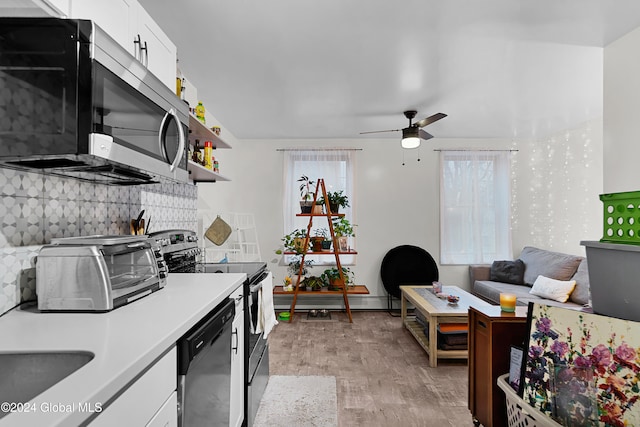 kitchen with white cabinets, ceiling fan, tasteful backsplash, light hardwood / wood-style floors, and stainless steel appliances