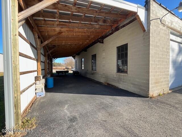 view of parking / parking lot featuring a carport