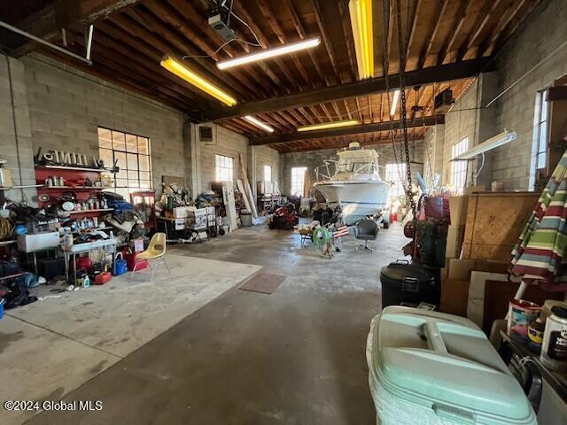 garage with a workshop area and a garage door opener