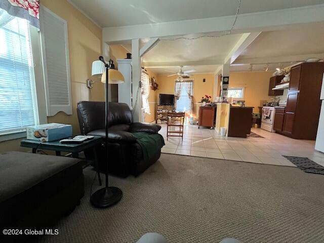 tiled living room featuring ceiling fan