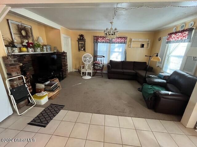 living room with a chandelier, a healthy amount of sunlight, and light tile patterned flooring