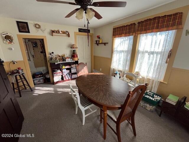 dining room with carpet and ceiling fan