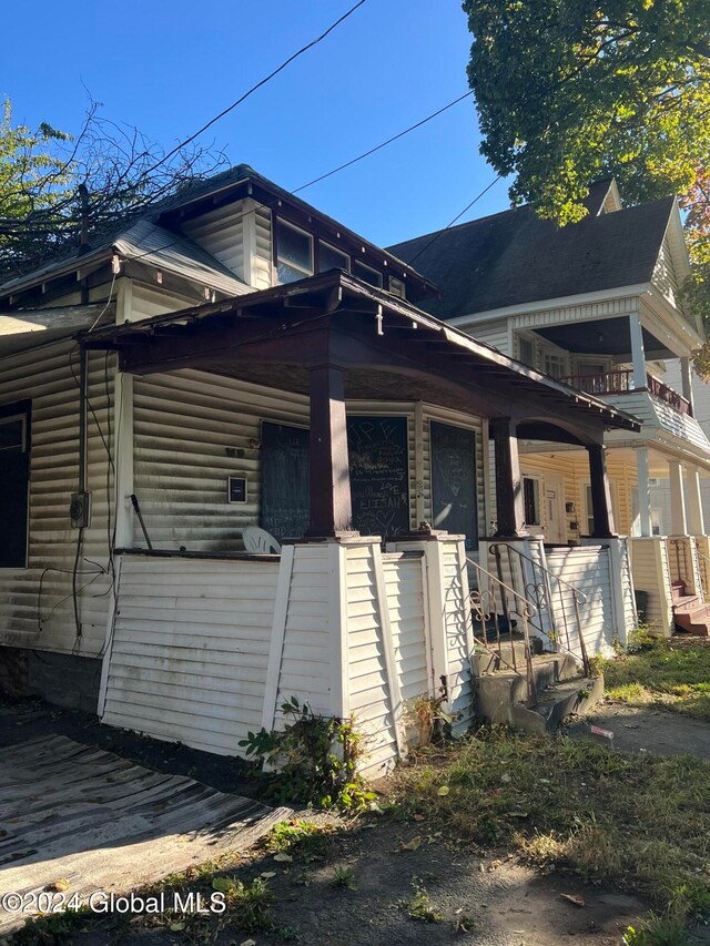 view of side of home with a porch