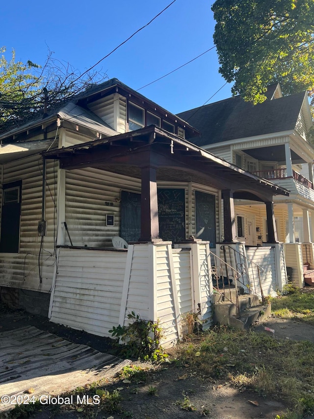 view of home's exterior with a balcony and covered porch