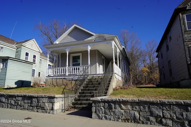 bungalow with a porch and a front yard