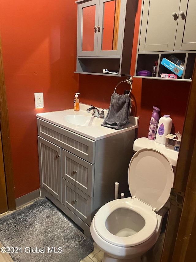 bathroom featuring vanity and toilet