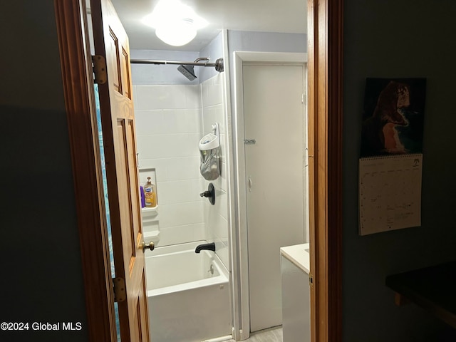 bathroom with vanity and tiled shower / bath combo