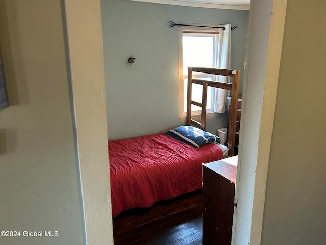 bedroom with dark hardwood / wood-style flooring