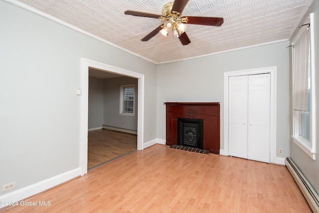 unfurnished living room featuring baseboard heating, ceiling fan, light hardwood / wood-style floors, and ornamental molding