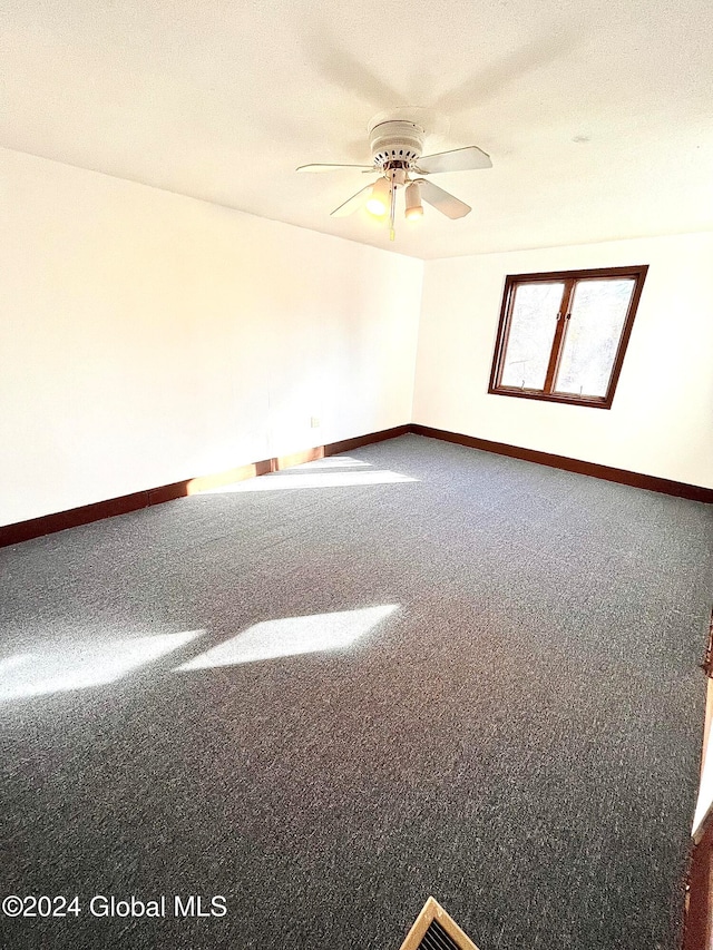 carpeted spare room with a textured ceiling and ceiling fan