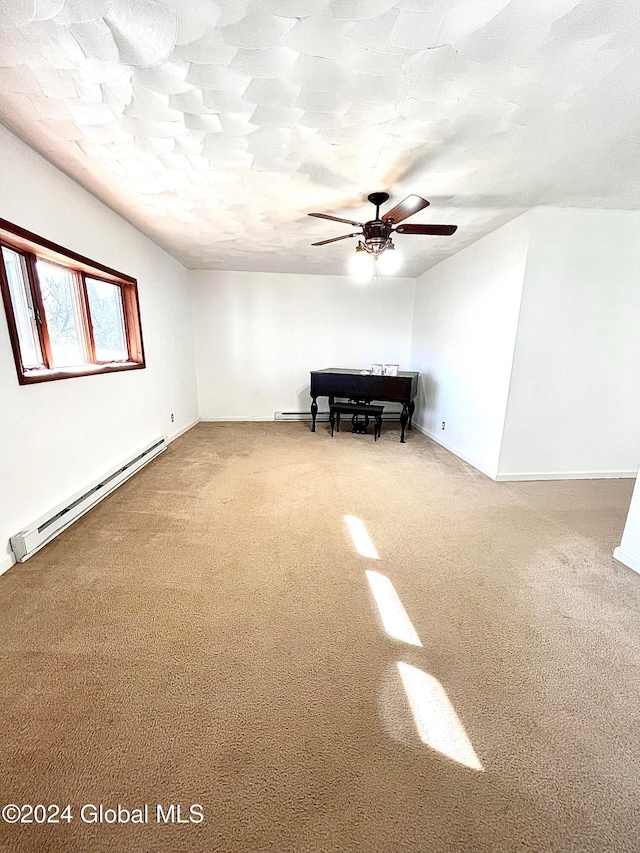 unfurnished room featuring carpet floors, baseboard heating, and ceiling fan