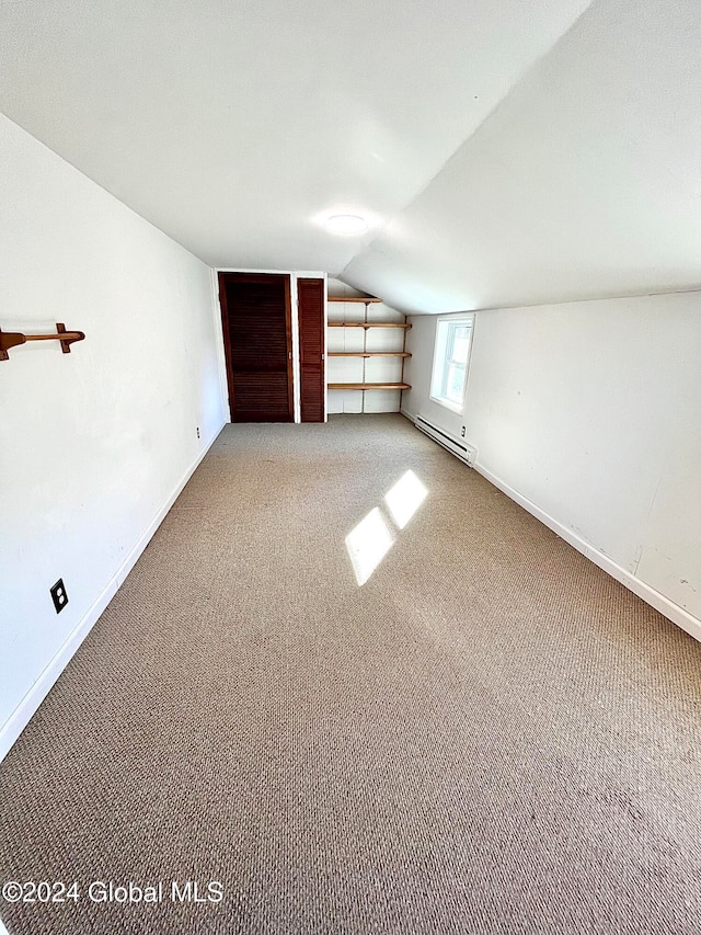 additional living space featuring carpet, lofted ceiling, and baseboard heating