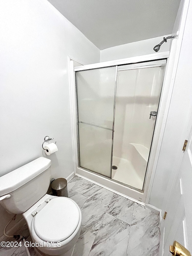 bathroom with toilet and walk in shower