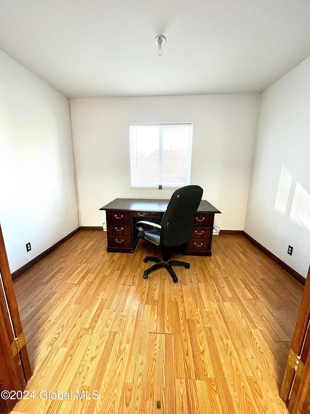 office space with light hardwood / wood-style flooring