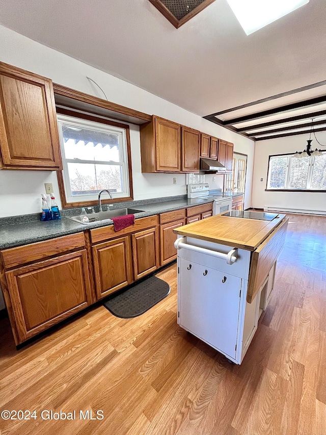 kitchen with sink, white electric stove, light wood-type flooring, a baseboard radiator, and butcher block counters