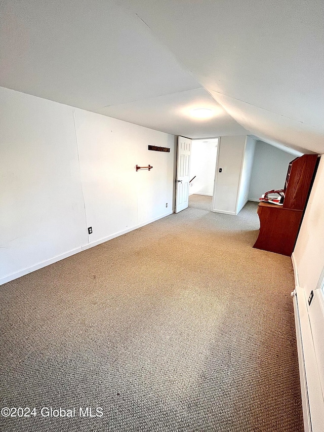 bonus room featuring baseboard heating, carpet floors, and lofted ceiling