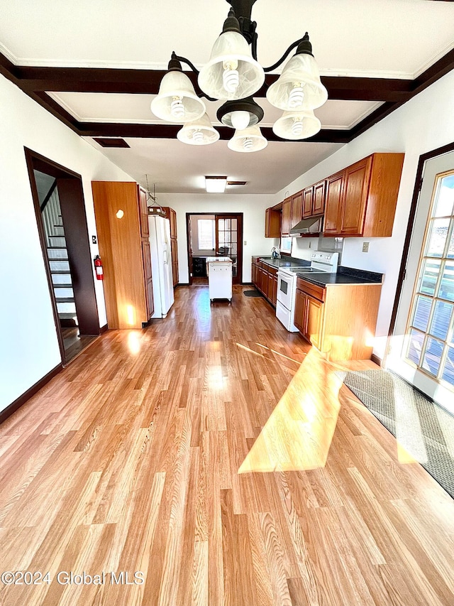 kitchen with light wood-type flooring, ornamental molding, white appliances, beam ceiling, and a center island