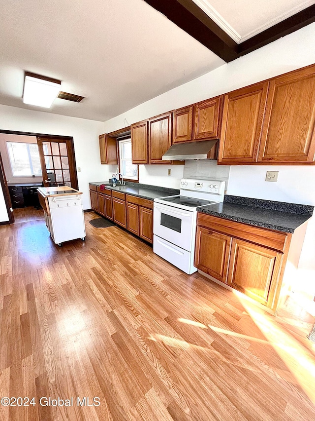 kitchen featuring white range with electric cooktop, sink, and light wood-type flooring