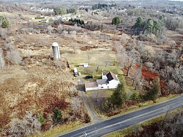 birds eye view of property with a rural view